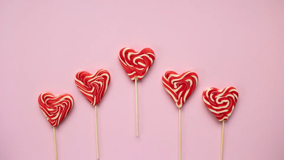 Heart Shaped Lollipops 4K Wallpaper Pink Background Aesthetic - Food wallpaper - 4K